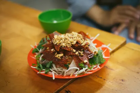 Vermicelli noodle salad with grilled pork, herbs and crushed peanuts