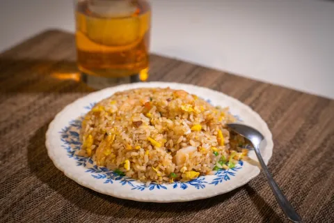 Plate of fried rice with egg and corn