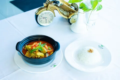 Coconut curry in a pot served with steamed rice